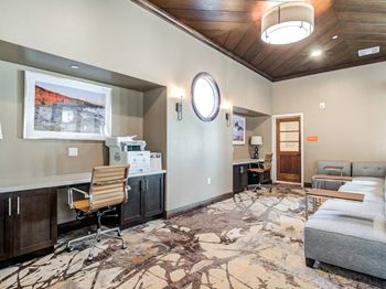 A room with a wooden ceiling and a rug on the floor.